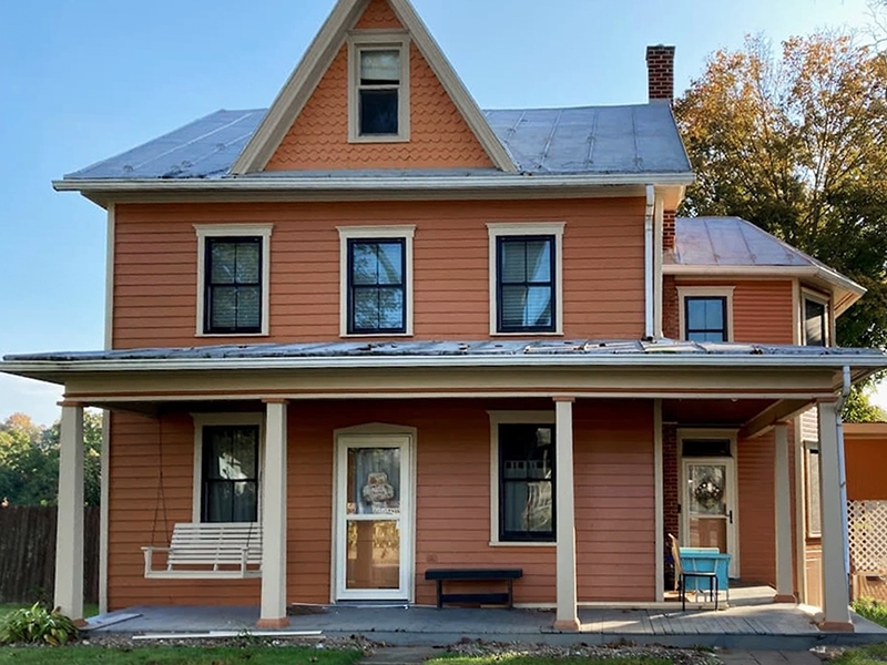 Curbside view of a Newport home with Pella replacement double-hung windows.