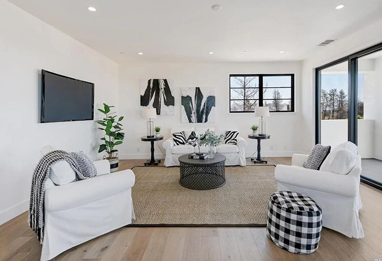 Living room in Santa Rosa home with newly installed Pella patio doors and wood windows.