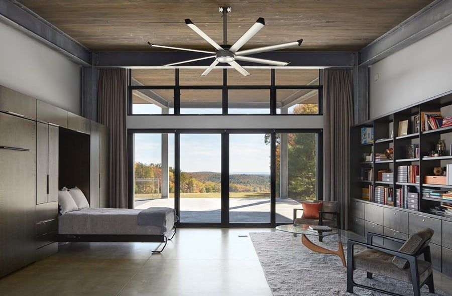 Black patio doors in a bedroom with a landscape view