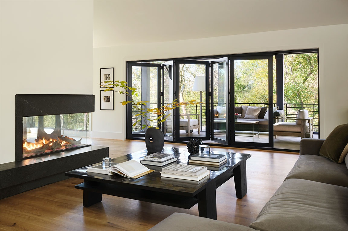 Black patio doors in a bedroom with a landscape view