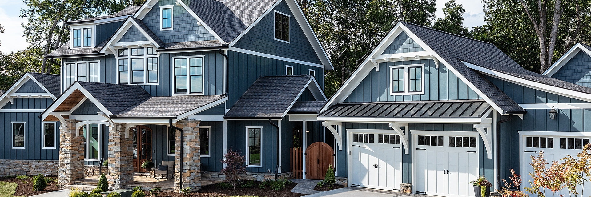 Exterior shot of a blue farm style home.