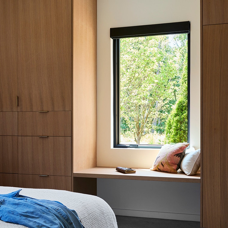 Mid-century modern bedroom featuring large window above reading nook.