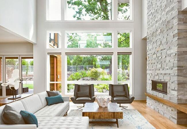 Contemporary living room with big white picture windows.