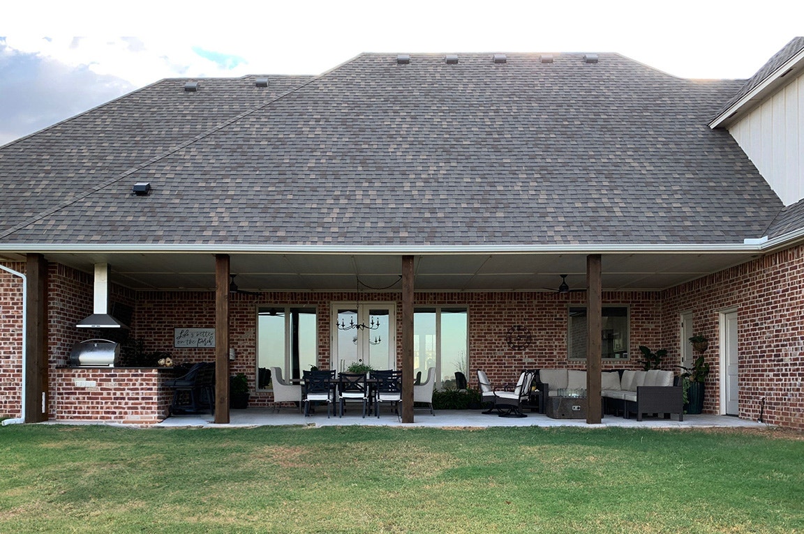 Before image of an open patio with awning overhead.