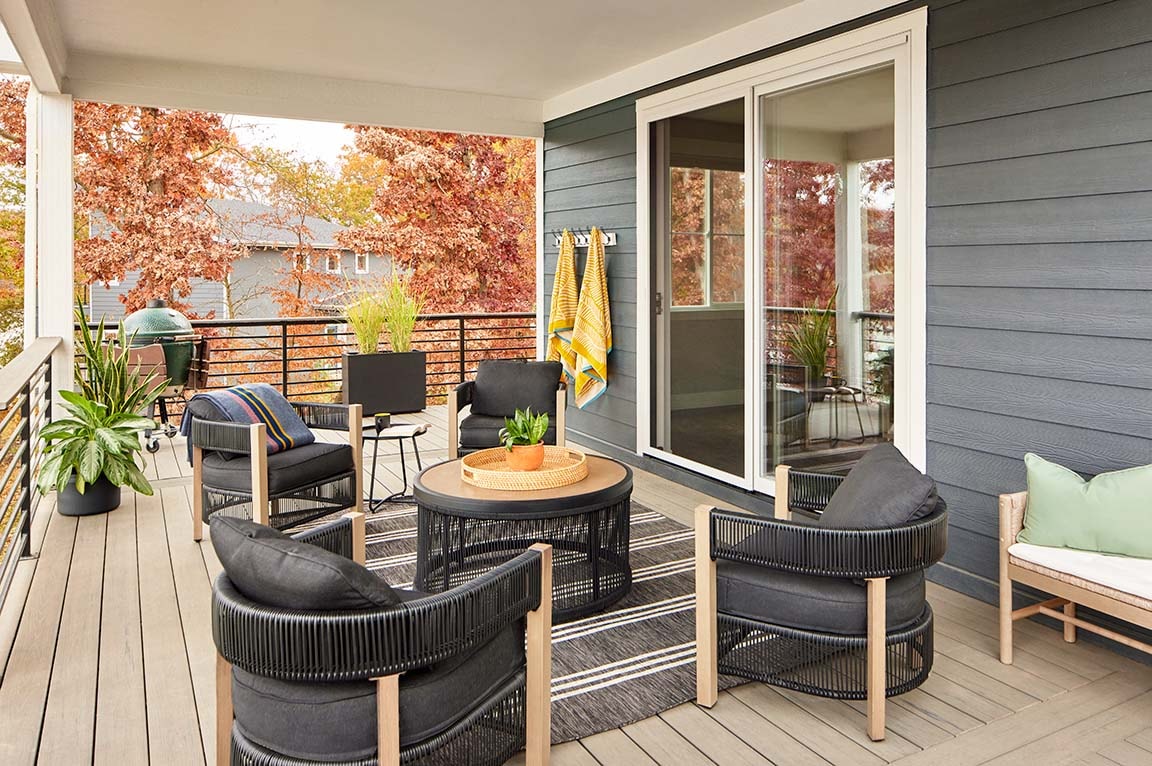 black sliding patio door open to a brick-floored patio