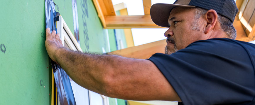 A Pella installer is working on new home construction.