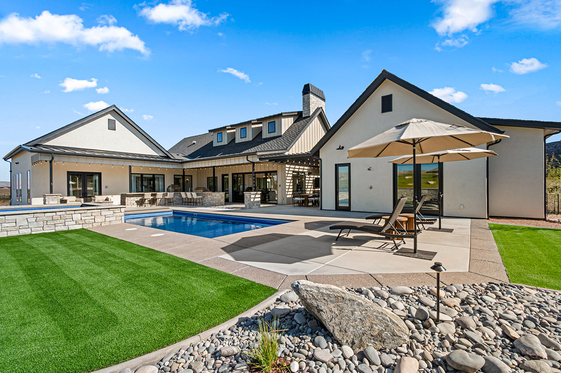 Backyard of Grand Junction home showing black patio doors.