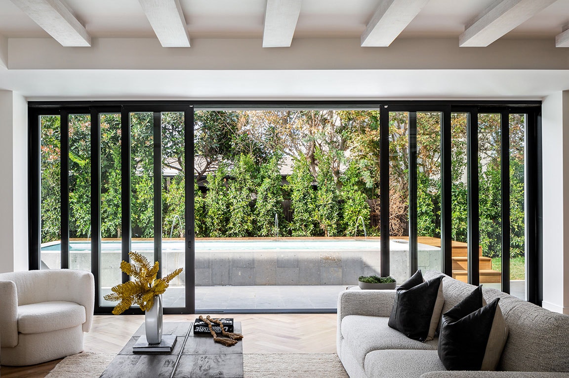 A modern living room with sliding glass doors, showcasing a seamless indoor-outdoor connection, highlighting sliding door ideas.