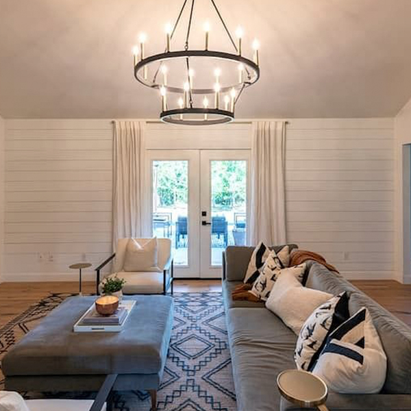 a set of white hinged doors at the far end of a living room