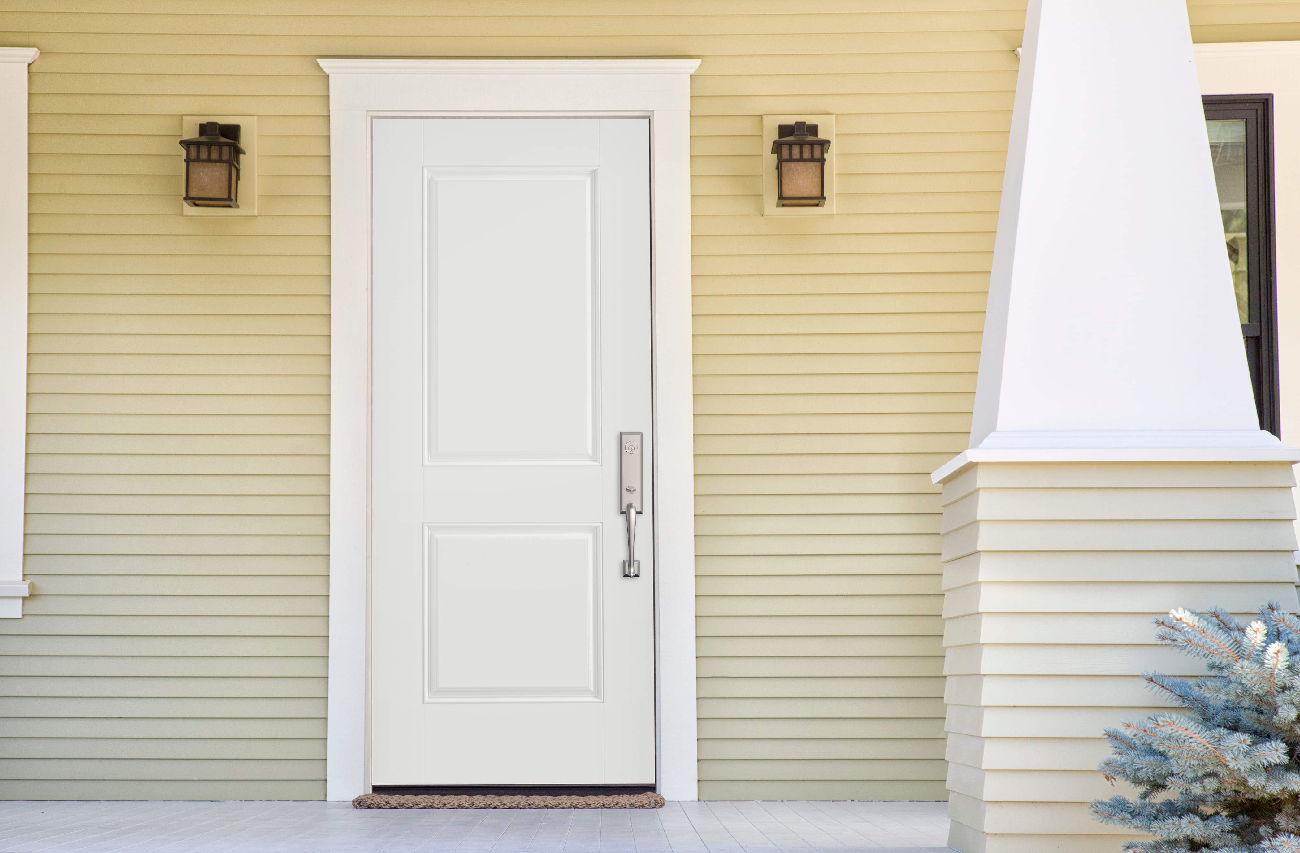 Stylish steel door surrounded by traditional trim and clapboard siding