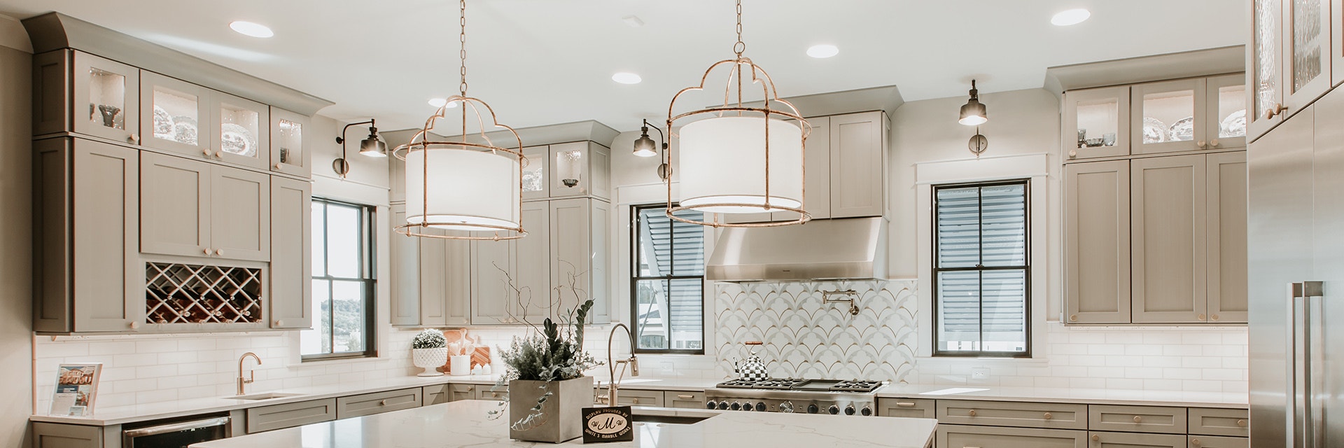 Elegant kitchen with muted colors featuring black single-hung windows with black traditional grilles.