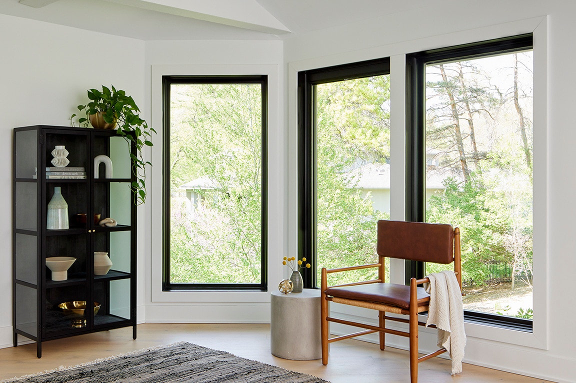 Mid-century modern room with three, large black windows.