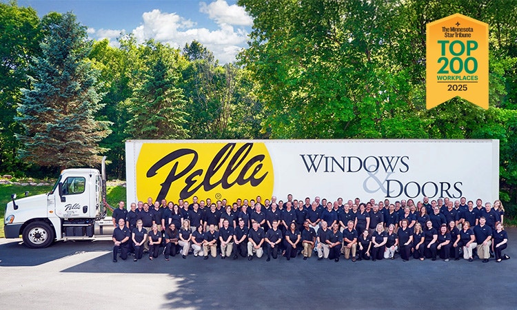 A large group picture of the Minnesota Pella Team, arranged in front of a Pella semi truck trailer.