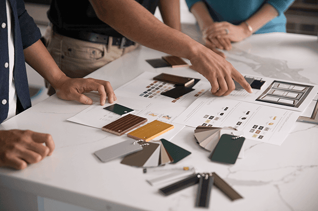 three people reviewing swatches and samples for their new windows