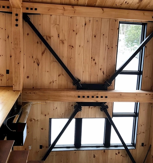 Interior view of newly installed black Pella windows for Hinesburg cabin.