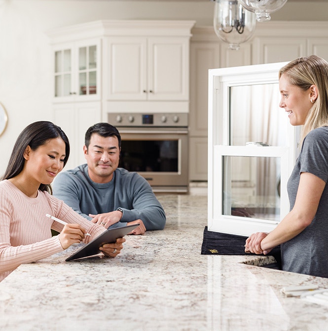 Columbus couple consults in a modern kitchen with a window display.