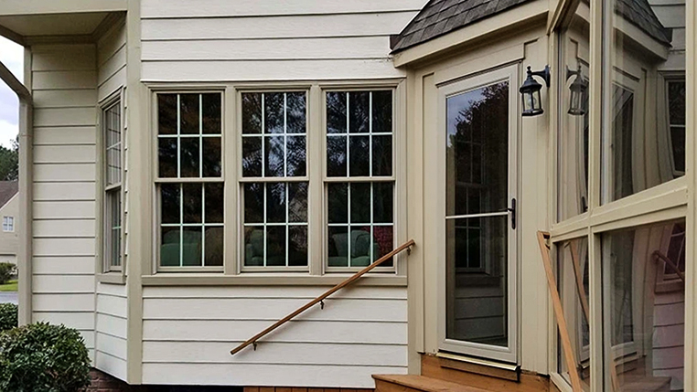 Backyard of Glen Allen home with newly installed tan windows and patio door.