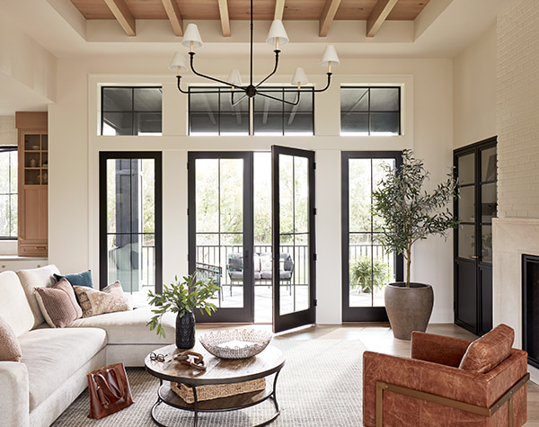 A set of white hinged doors are open in a wood kitchen
