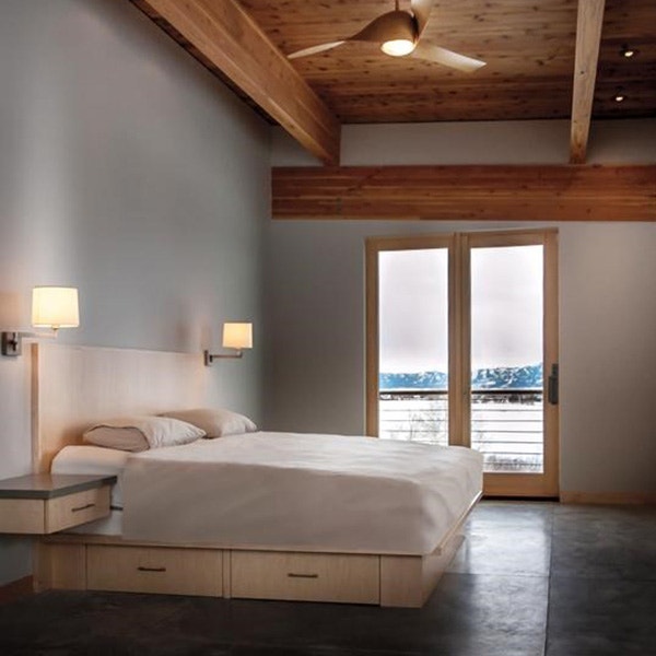 Contemporary, wood accented bedroom with modern sliding glass door.