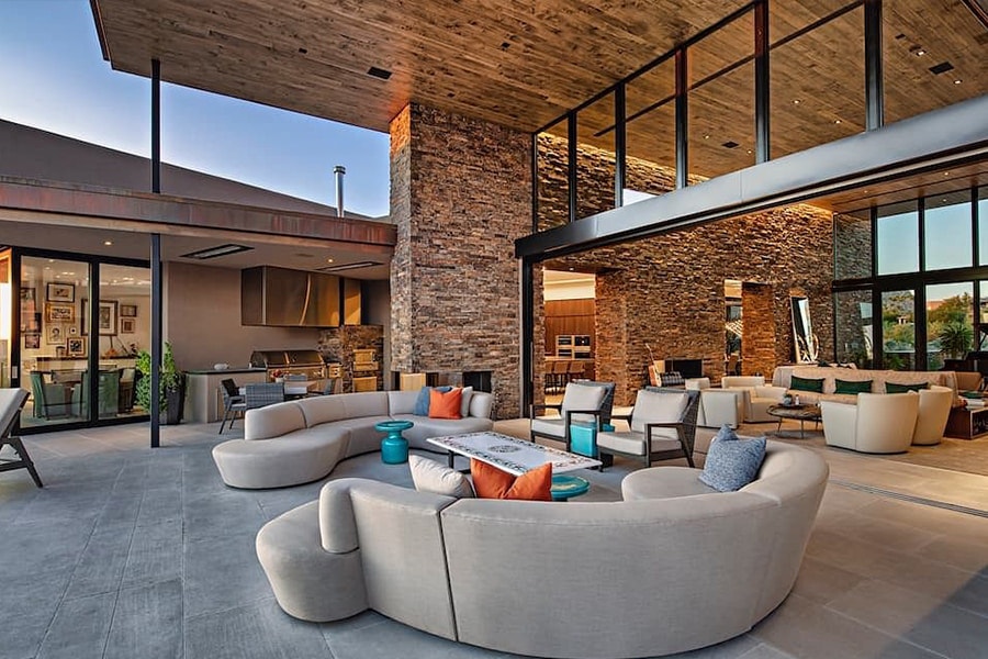 An expansive outdoor living space connected to the home interior via a Pella Reserve multi-slide door