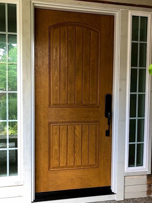 Fiberglass front door with wood stain and matte black hardware