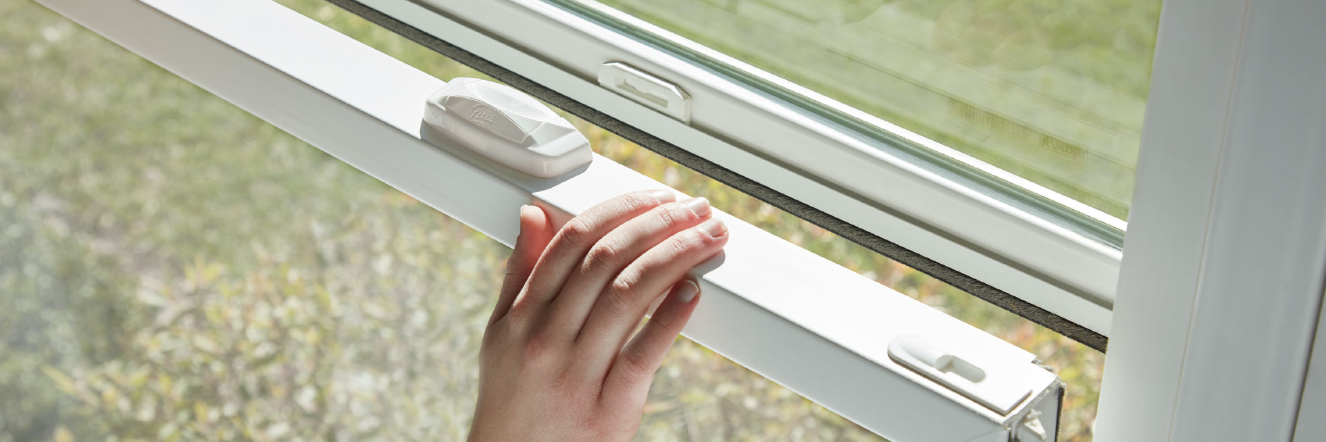 woman opening a single-hung window