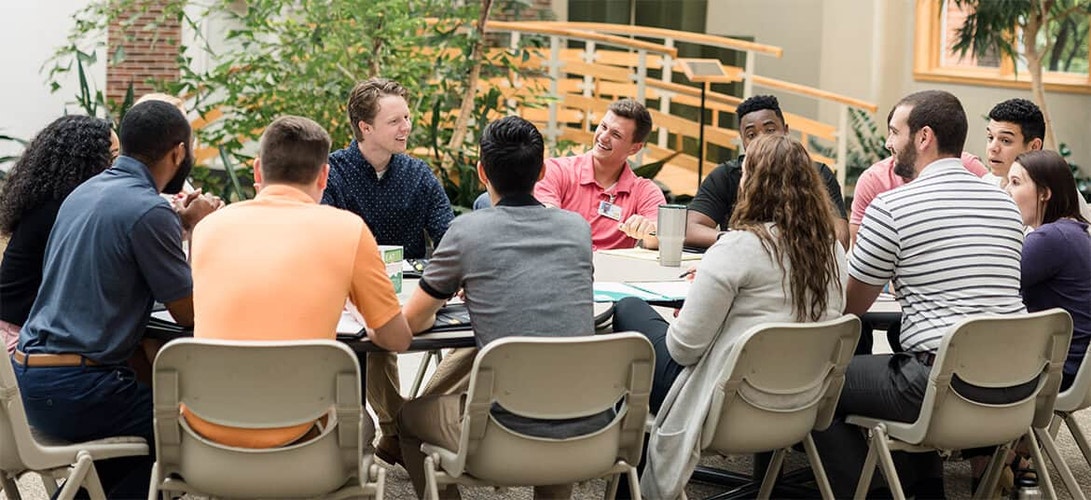 a team of interns meeting around a table