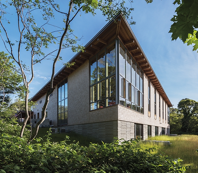 Exterior view of Eastham library addition highlighting wall of glass.
