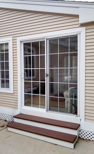 Before image of a West Springfield condo with old vinyl sliding doors.