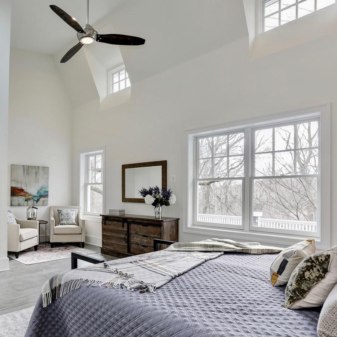 White bedroom with windows placed high near the ceiling to let in lots of light