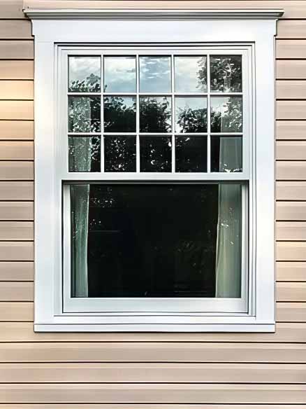 Restored historic wood replacement window with white grilles