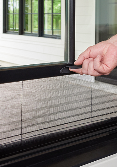 The Hidden Screen innovation is featured on a black window that a woman is opening to display the screen.