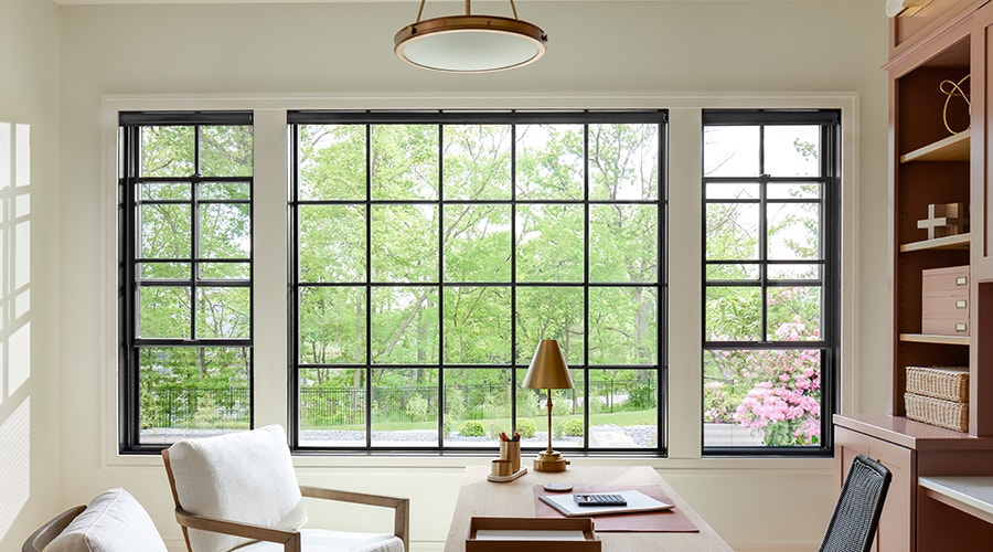 Double-Hung and fixed black windows in office of home.