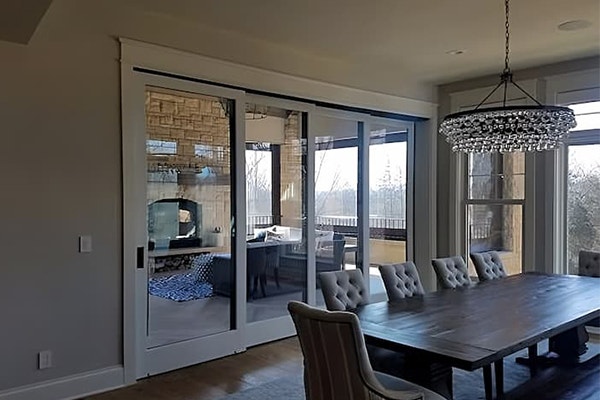 Contemporary white dining room with matching multi-slide patio door