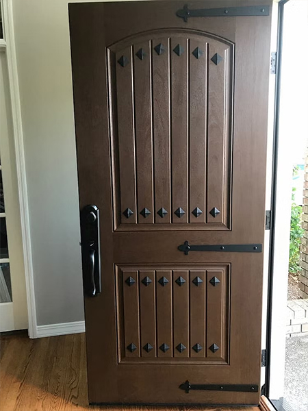 A new Pella fiberglass front door is opened and viewed from the interior of the home.