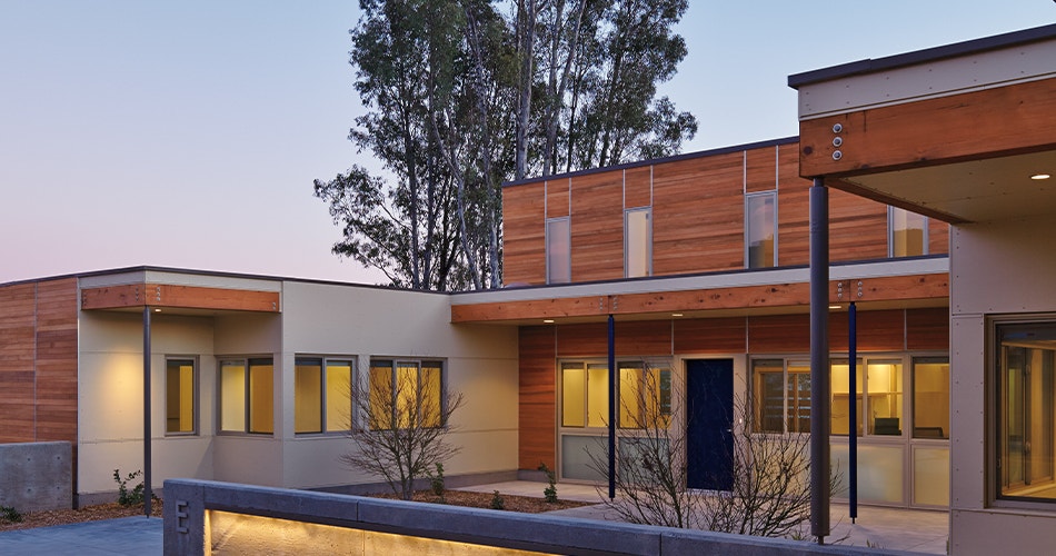 Los Angeles contemporary home with wood paneling and wood casement windows.