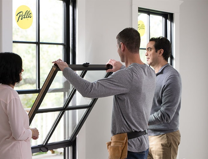 two commercial pros working on a double-hung window