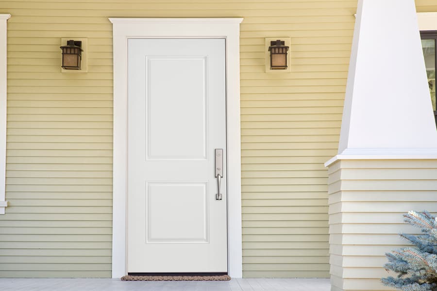 white steel front entry door with white trim and yellow siding