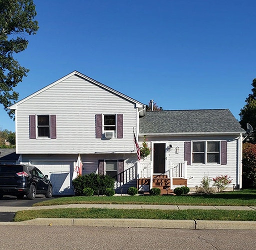 Curbside view of an Essex home in need of bay window replacement.