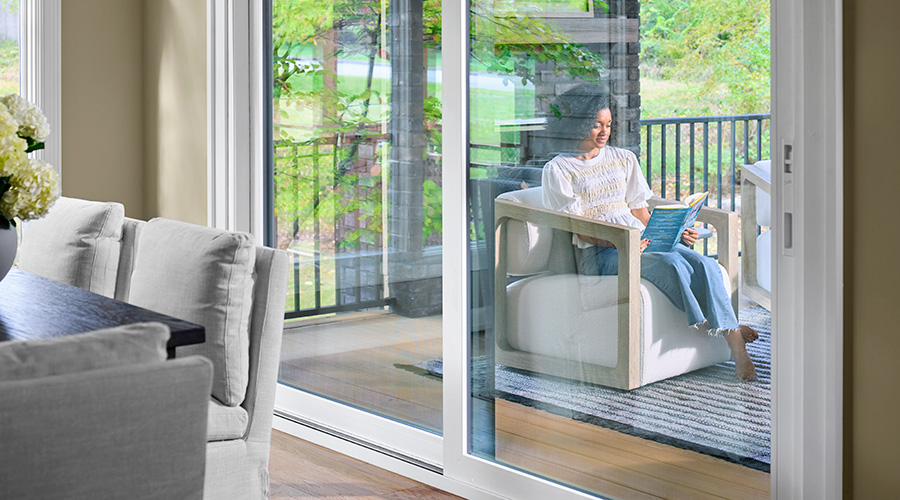White sliding patio doors opening to a covered porch with outdoor seating.