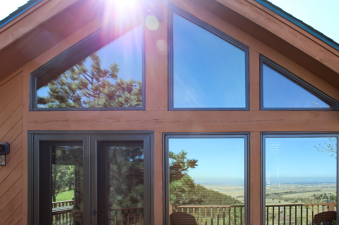 Triangle and rectangular windows with scenic mountain view and sunlight