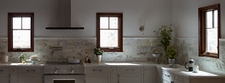 three dark casement windows taupe kitchen gray counters