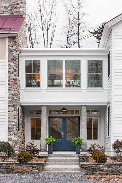 Image of the exterior of a Berkshire home highlighting a newly installed Pella blue front door.