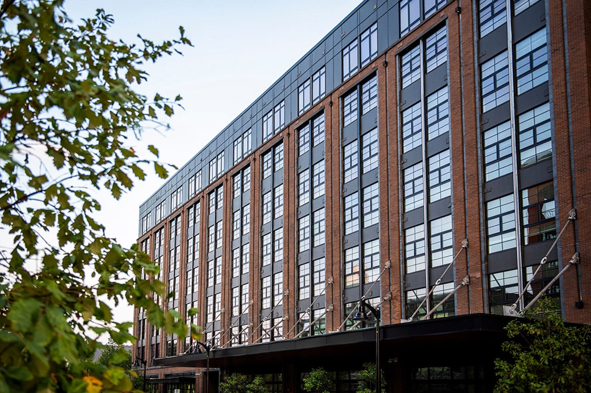 Baltimore apartment complex with fiberglass windows on brick facade.  