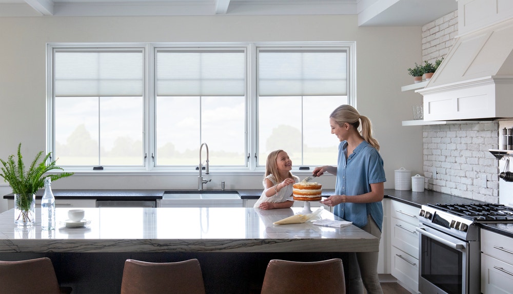 mom and daughter in kitchen lifestyle series awning windows