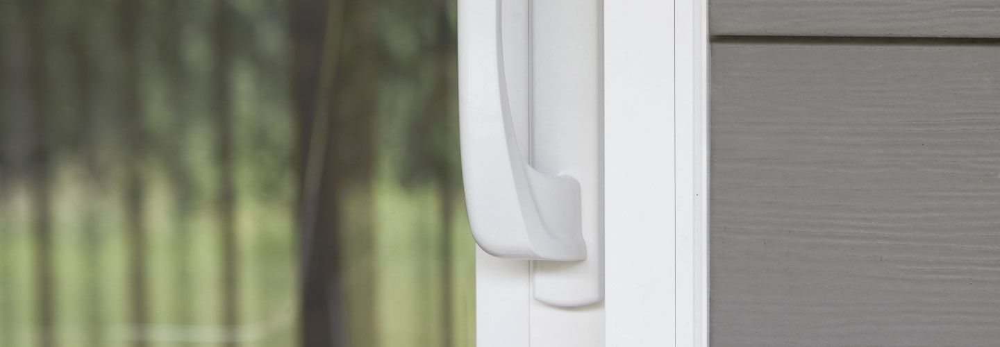 tight shot of vinyl patio door hardware handle in white