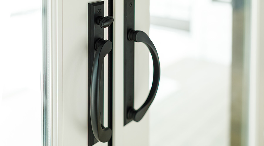 tight shot of vinyl patio door hardware handle in white
