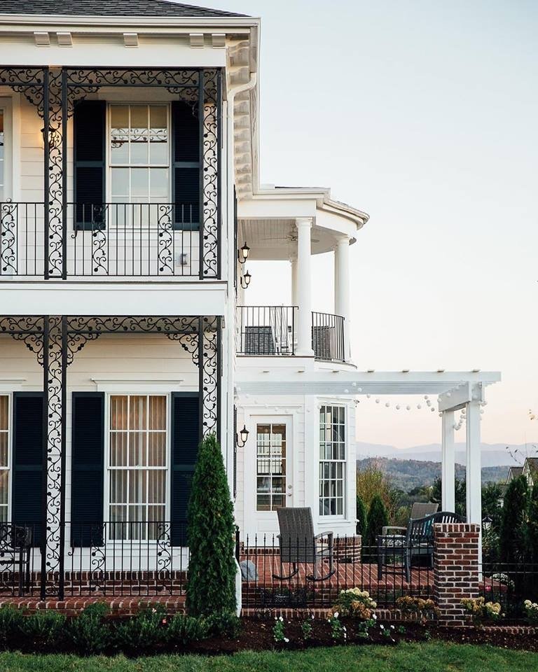 White Windows & Black Shutters For Traditional Style Home Traditional style two story white house with white double-hung windows and black shutters