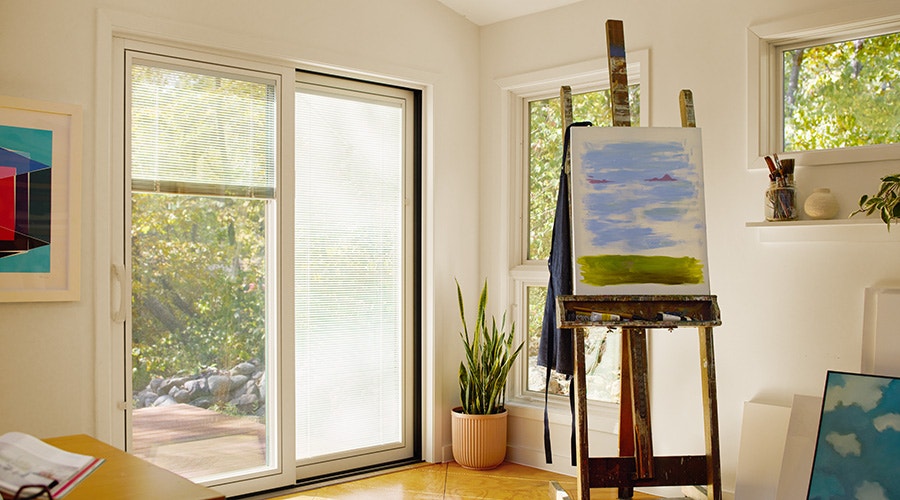 top part of a four panel sliding door with blinds between the glass