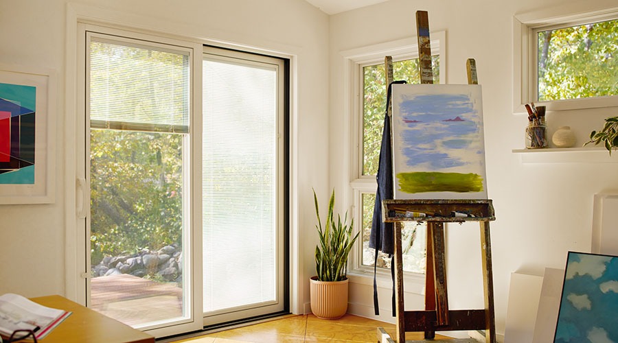 top part of a four panel sliding door with blinds between the glass